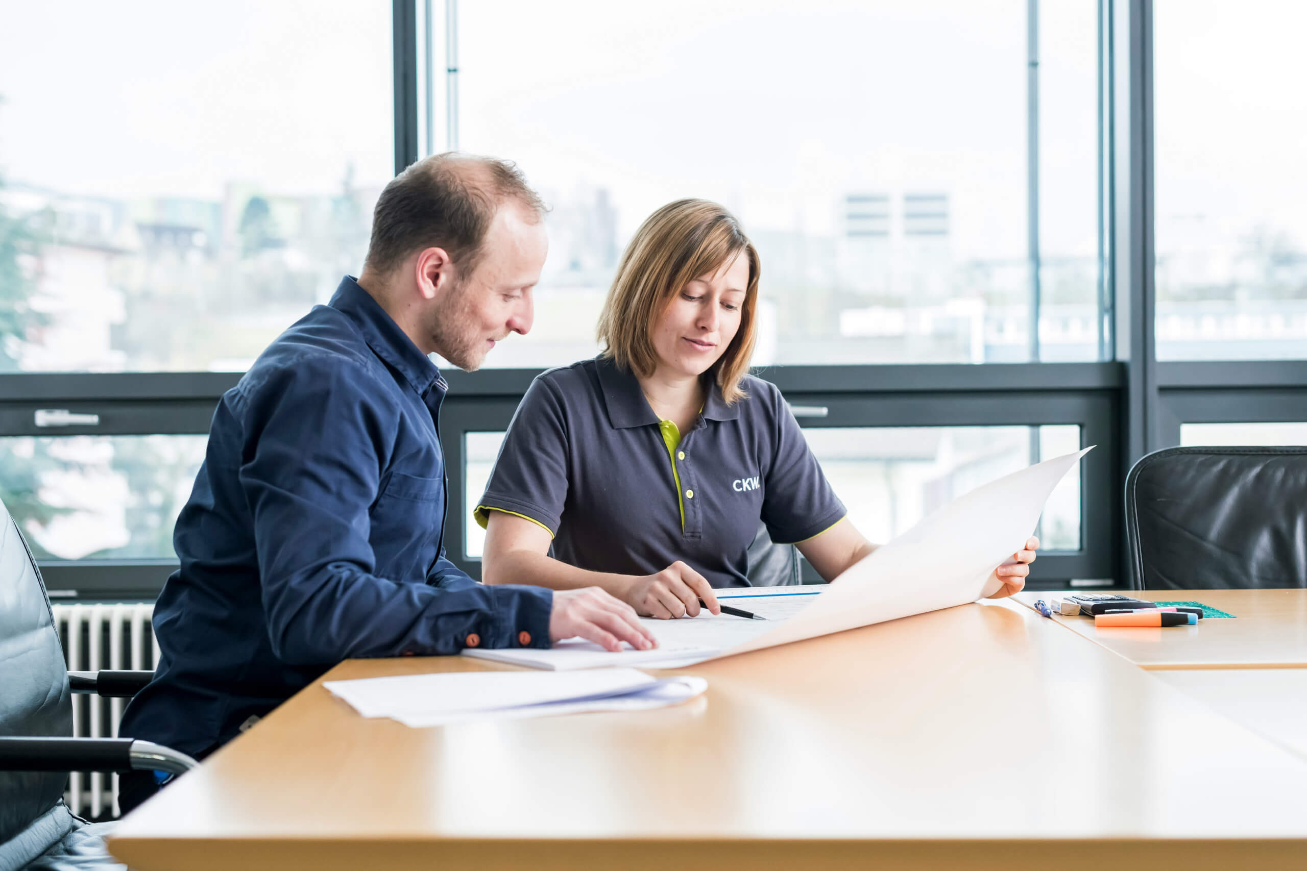 Team collaborating in a modern office using Microsoft 365 tools for productivity, security, and communication
